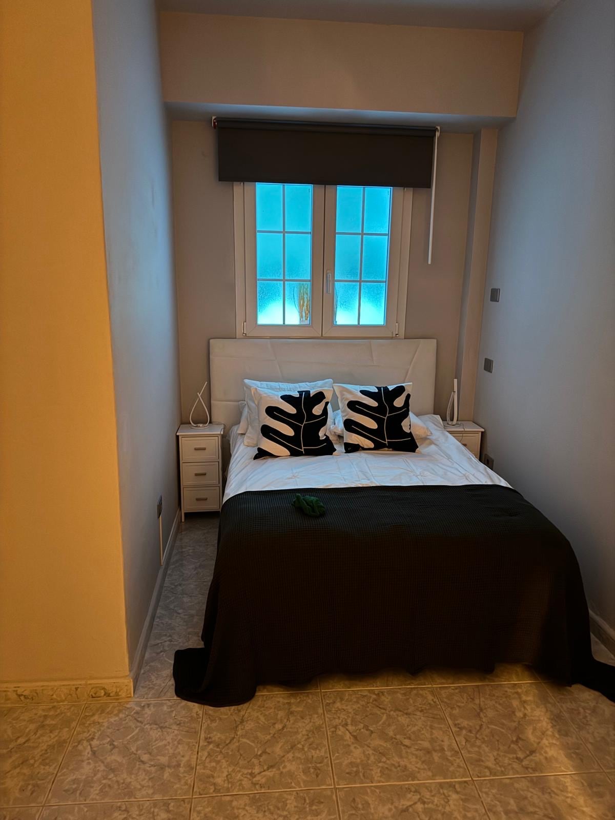 Studio apartment double bed with bedside storage